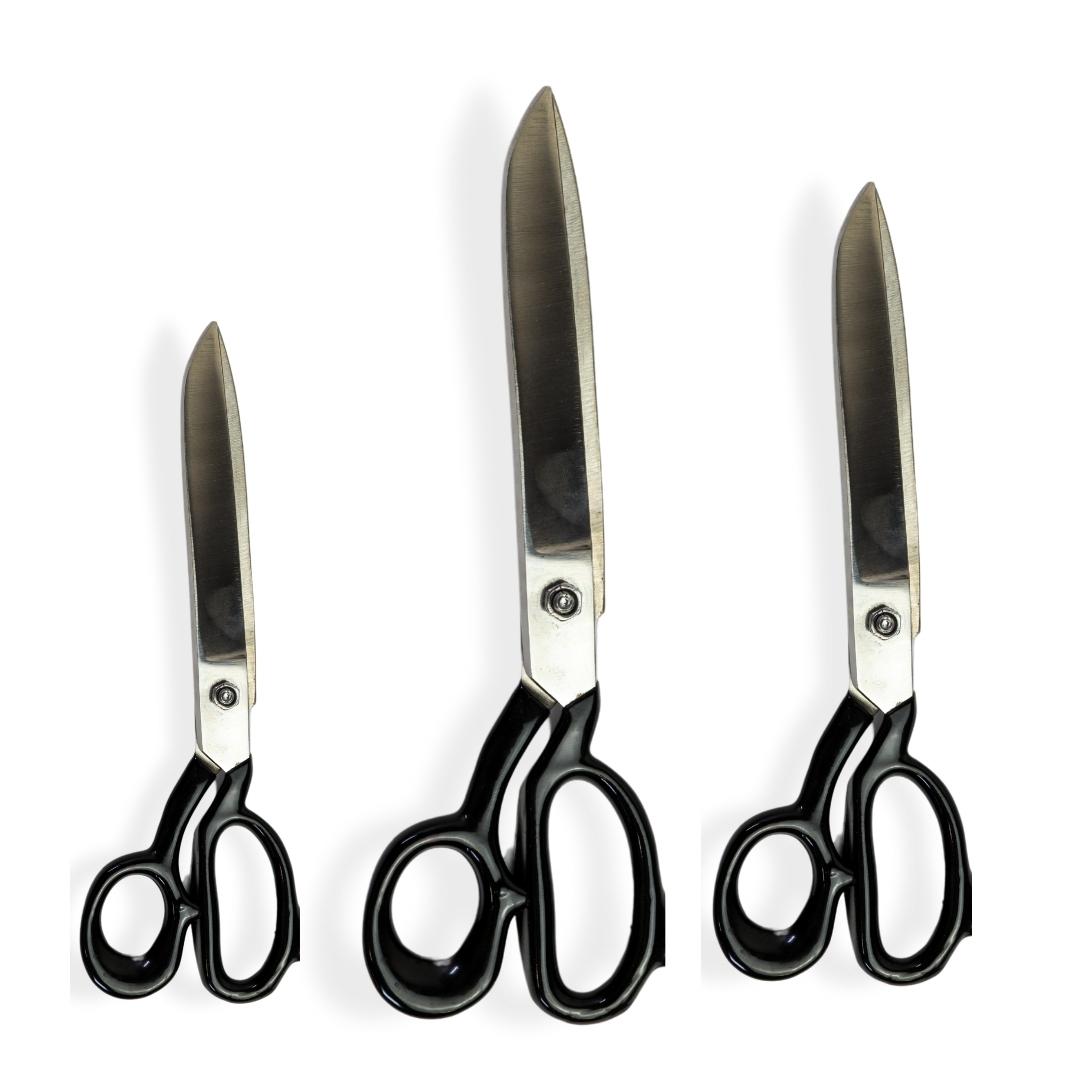 "Heavy duty scissors cutting fabric on worktable"